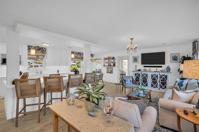 1769 Brookside Blvd, Largo, FL 33770 - living area with a chandelier and light wood-type flooring
