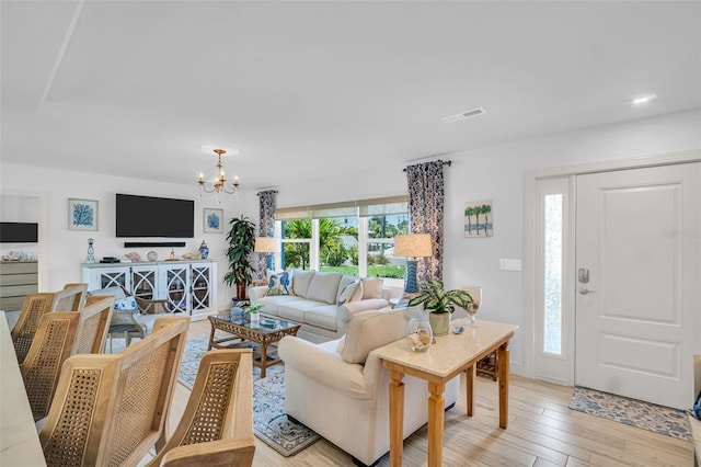 1769 Brookside Blvd, Largo, FL 33770 - living room with a chandelier and light wood-style floors