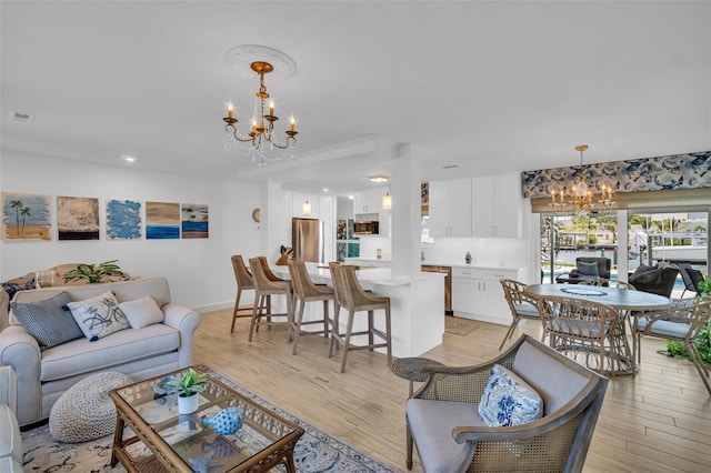 1769 Brookside Blvd, Largo, FL 33770 - living area with a chandelier and light wood-style floors