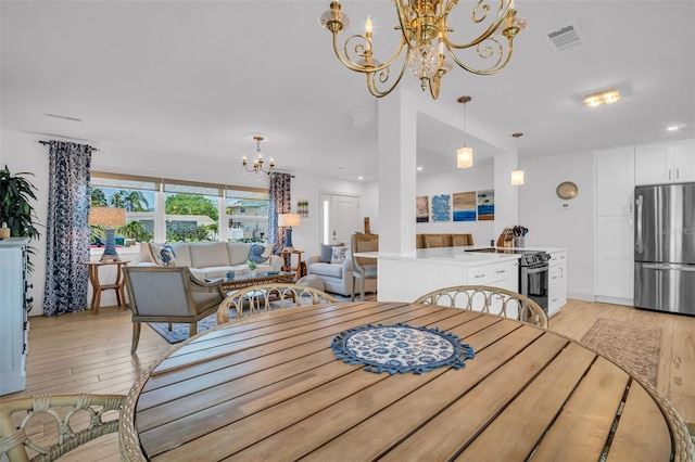 1769 Brookside Blvd, Largo, FL 33770 - dining space with a chandelier and light wood finished floors
