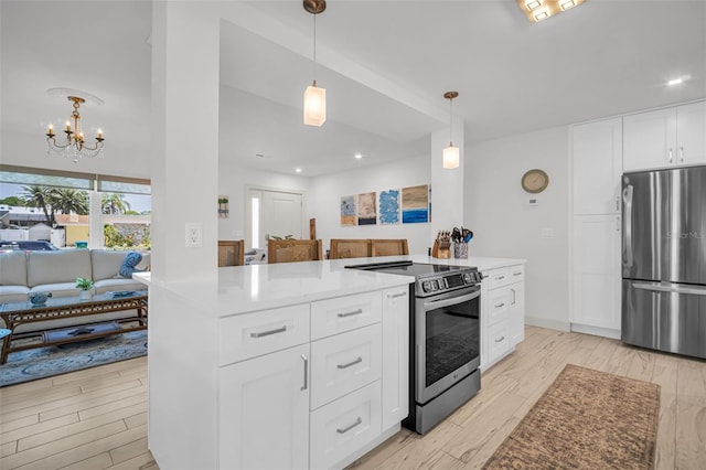 1769 Brookside Blvd, Largo, FL 33770 - kitchen featuring appliances with stainless steel finishes, a chandelier, white cabinetry, hanging light fixtures, and recessed lighting