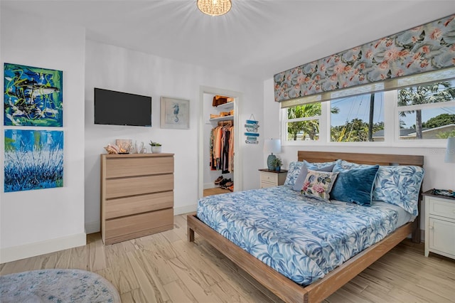 1769 Brookside Blvd, Largo, FL 33770 - bedroom featuring a spacious closet, light wood-type flooring, baseboards, and a closet
