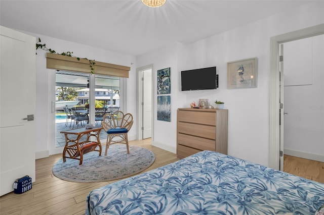 1769 Brookside Blvd, Largo, FL 33770 - bedroom featuring access to exterior, light wood-type flooring, and baseboards