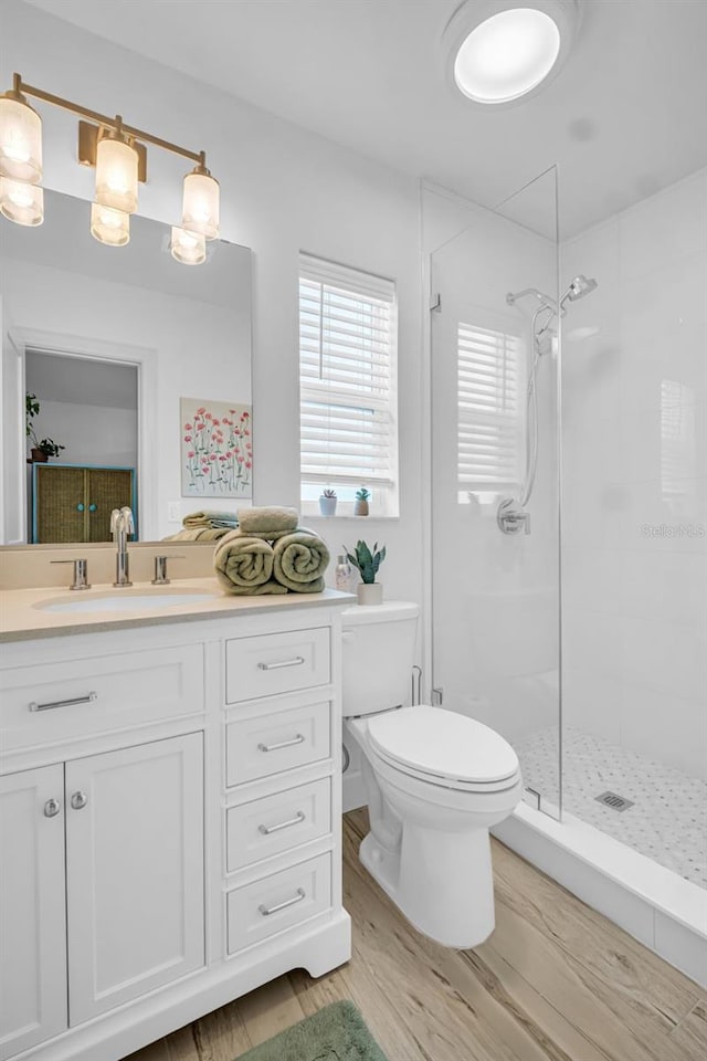 1769 Brookside Blvd, Largo, FL 33770 - full bathroom featuring wood finished floors, a stall shower, toilet, and vanity