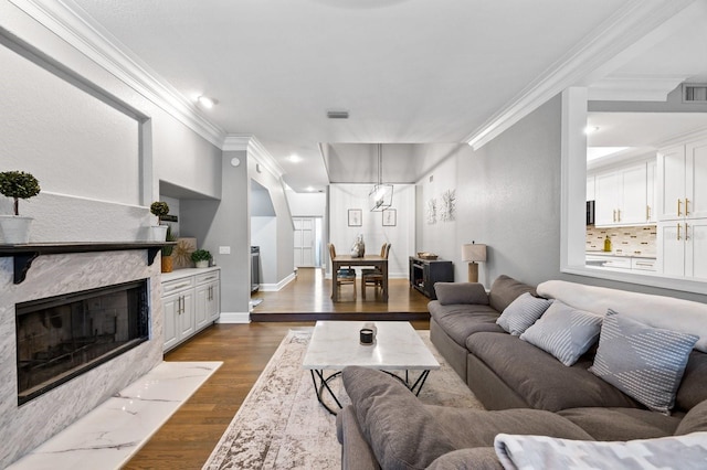 9722 Tiffany Oaks Ln, Tampa, FL 33612 - living area featuring ornamental molding, dark wood finished floors, a fireplace with flush hearth, baseboards, and recessed lighting