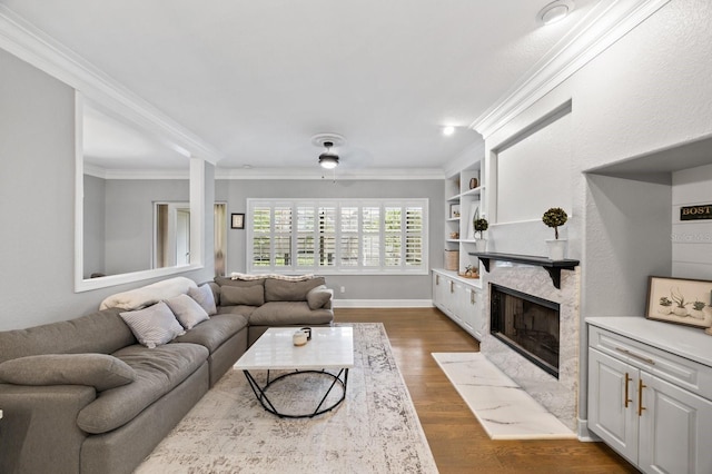 9722 Tiffany Oaks Ln, Tampa, FL 33612 - living area featuring a fireplace with flush hearth, ornamental molding, dark wood-type flooring, and baseboards