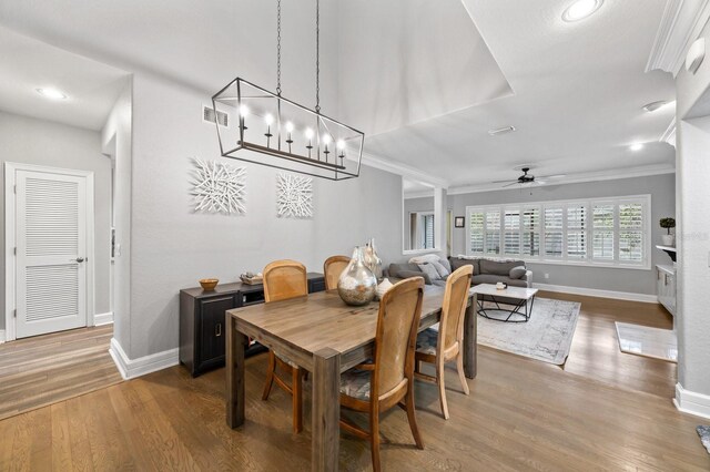 9722 Tiffany Oaks Ln, Tampa, FL 33612 - dining space with baseboards, crown molding, ceiling fan, wood finished floors, and recessed lighting