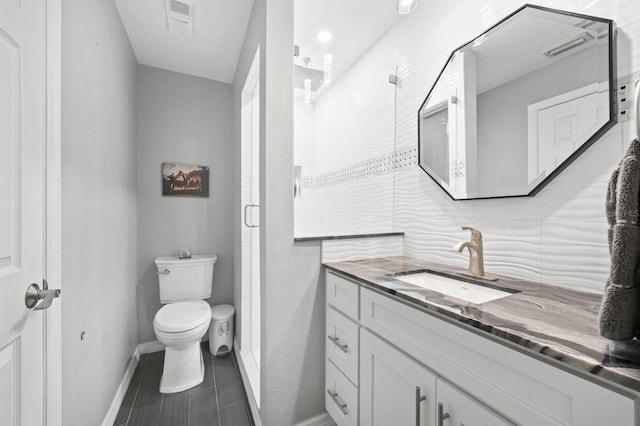 9722 Tiffany Oaks Ln, Tampa, FL 33612 - bathroom featuring a stall shower, toilet, vanity, and baseboards