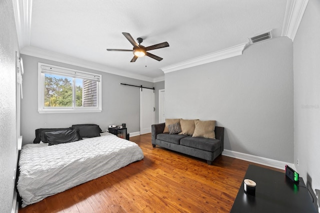 9722 Tiffany Oaks Ln, Tampa, FL 33612 - bedroom featuring a barn door, crown molding, hardwood / wood-style floors, a ceiling fan, and baseboards