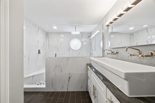 9722 Tiffany Oaks Ln, Tampa, FL 33612 - bathroom featuring a marble finish shower, double vanity, and wood finished floors