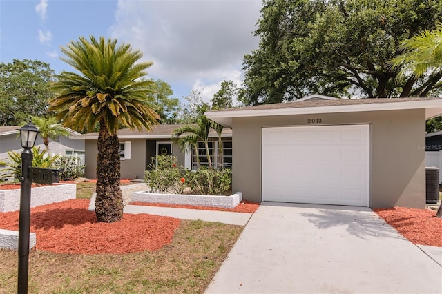 2012 Scotland Dr, Clearwater, FL 33763 - ranch-style home featuring stucco siding, driveway, and an attached garage