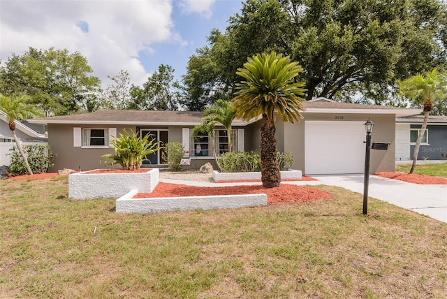 2012 Scotland Dr, Clearwater, FL 33763 - single story home featuring a garage, stucco siding, driveway, and a front lawn