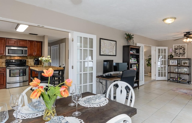 2012 Scotland Dr, Clearwater, FL 33763 - dining space featuring light tile patterned floors, french doors, and a ceiling fan