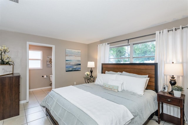 2012 Scotland Dr, Clearwater, FL 33763 - bedroom with light tile patterned flooring, baseboards, and ensuite bath
