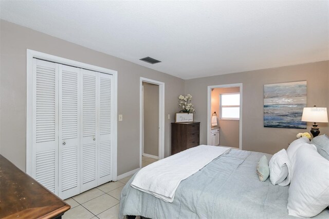 2012 Scotland Dr, Clearwater, FL 33763 - bedroom with light tile patterned flooring and a closet