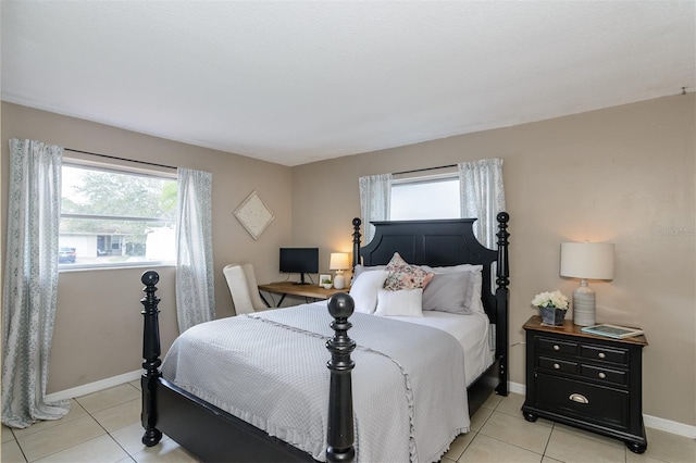 2012 Scotland Dr, Clearwater, FL 33763 - bedroom with multiple windows, baseboards, and light tile patterned floors