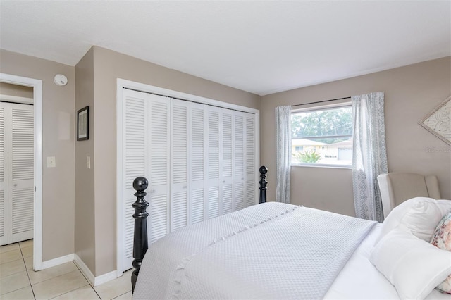 2012 Scotland Dr, Clearwater, FL 33763 - bedroom with light tile patterned floors, a closet, and baseboards