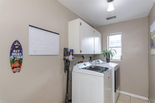 2012 Scotland Dr, Clearwater, FL 33763 - clothes washing area with cabinet space, washer and dryer, light tile patterned floors, and baseboards
