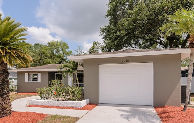 2012 Scotland Dr, Clearwater, FL 33763 - ranch-style house featuring stucco siding, concrete driveway, and an attached garage
