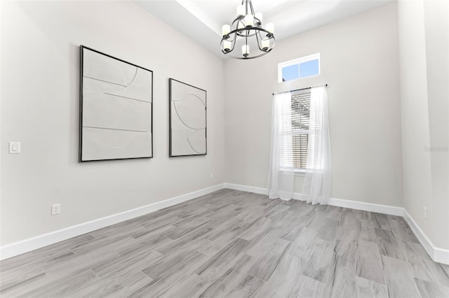 3888 Santa Caterina Blvd, Bradenton, FL 34211 - unfurnished room with a chandelier and light wood-type flooring