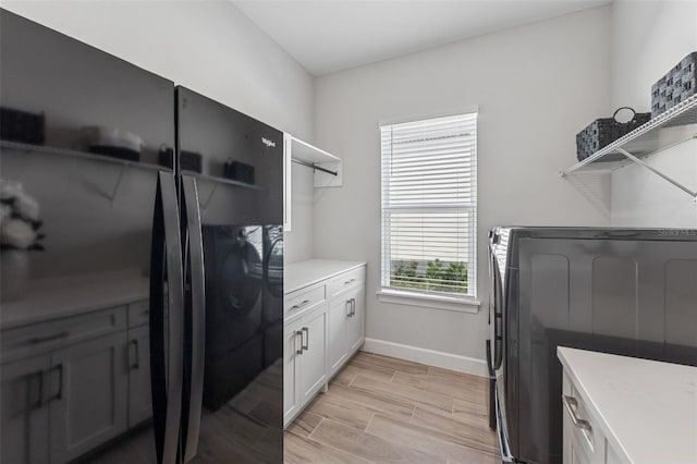 3888 Santa Caterina Blvd, Bradenton, FL 34211 - laundry area with light wood finished floors and cabinet space