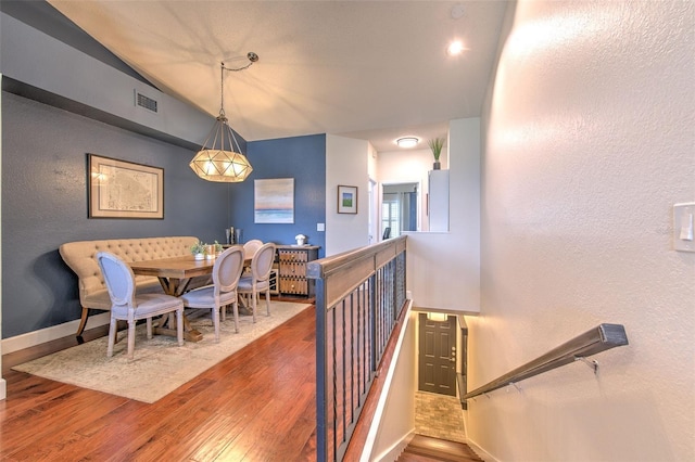 1111 Normandy Trace Rd Unit 1111, Tampa, FL 33602 - dining room with wood finished floors, vaulted ceiling, and a textured wall