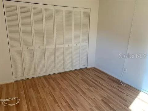 2720 Sand Hollow Ct Unit 156A, Clearwater, FL 33761 - unfurnished bedroom with light wood-style floors and a closet
