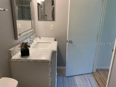 2720 Sand Hollow Ct Unit 156A, Clearwater, FL 33761 - bathroom featuring vanity, toilet, and baseboards