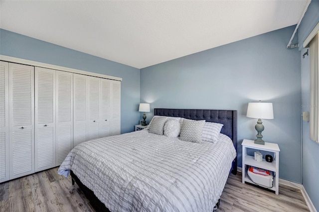 31 Island Way Unit 1403, Clearwater Beach, FL 33767 - bedroom with wood finished floors, a closet, and baseboards