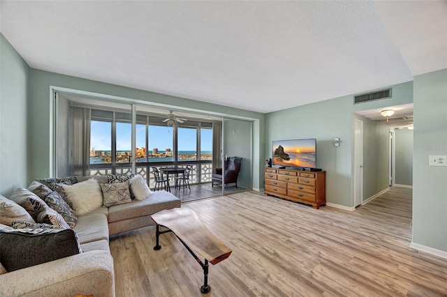 31 Island Way Unit 1403, Clearwater Beach, FL 33767 - living area with light wood finished floors, baseboards, and a ceiling fan