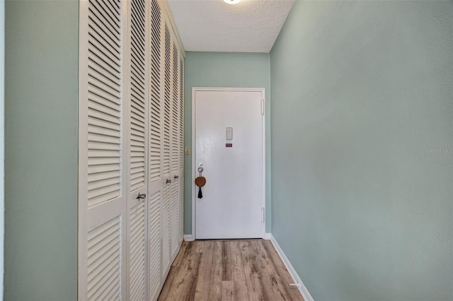 31 Island Way Unit 1403, Clearwater Beach, FL 33767 - hall with wood finished floors, baseboards, and a textured ceiling