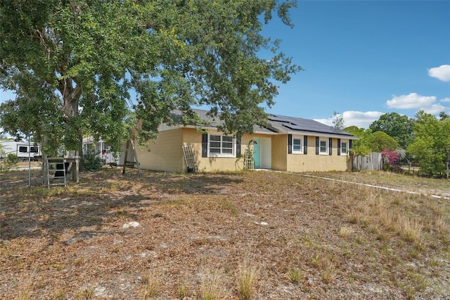 503 Holt Cir, Winter Haven, FL 33880 - view of front of property with solar panels, fence, and stucco siding