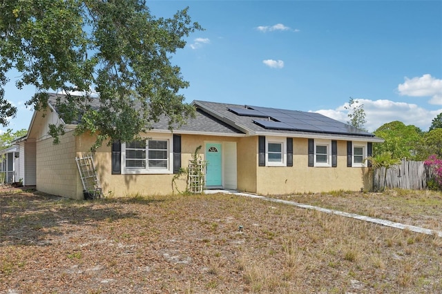 503 Holt Cir, Winter Haven, FL 33880 - single story home featuring solar panels, stucco siding, fence, and roof with shingles