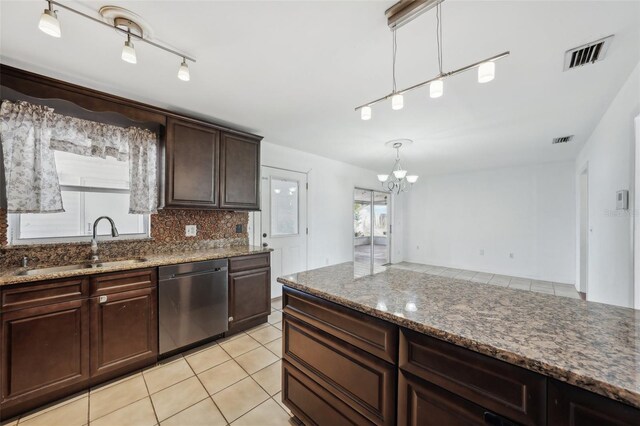 503 Holt Cir, Winter Haven, FL 33880 - kitchen featuring dishwasher, a sink, backsplash, a chandelier, and stone counters
