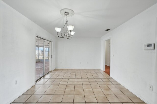 503 Holt Cir, Winter Haven, FL 33880 - empty room with a chandelier and light tile patterned flooring