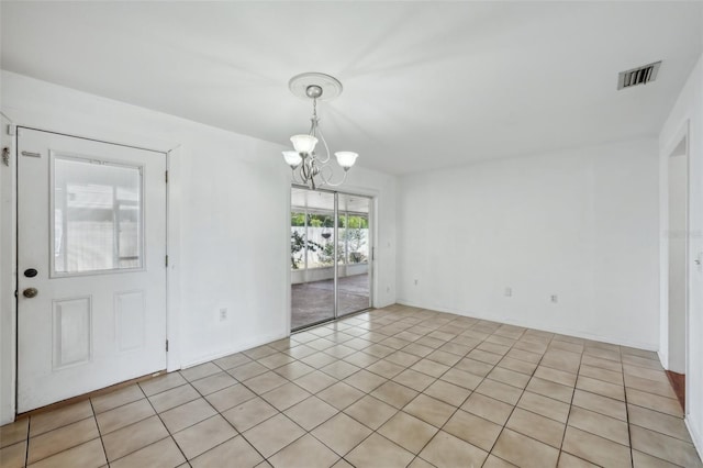 503 Holt Cir, Winter Haven, FL 33880 - spare room with a chandelier and light tile patterned floors