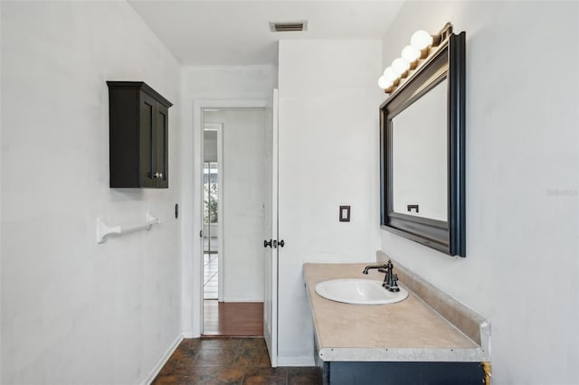 503 Holt Cir, Winter Haven, FL 33880 - bathroom featuring baseboards, stone finish floors, and vanity