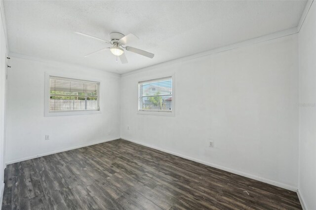 503 Holt Cir, Winter Haven, FL 33880 - spare room featuring healthy amount of natural light, dark wood-style flooring, ceiling fan, and crown molding