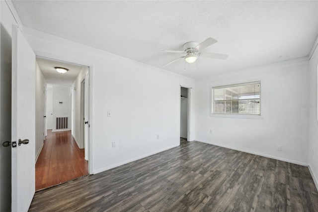 503 Holt Cir, Winter Haven, FL 33880 - unfurnished bedroom featuring dark wood-style flooring, a closet, a textured ceiling, baseboards, and a ceiling fan