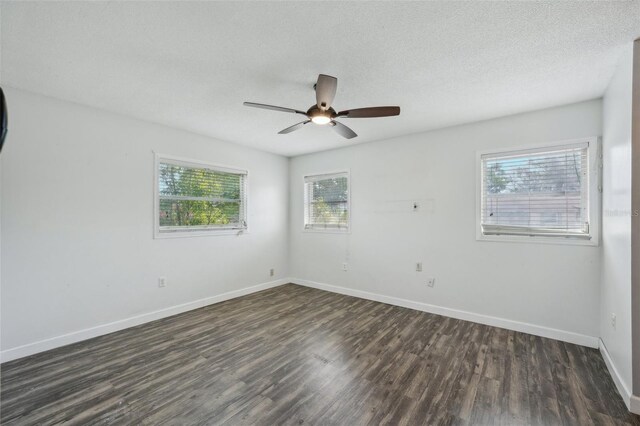 503 Holt Cir, Winter Haven, FL 33880 - spare room featuring dark wood-type flooring, baseboards, a ceiling fan, and a textured ceiling