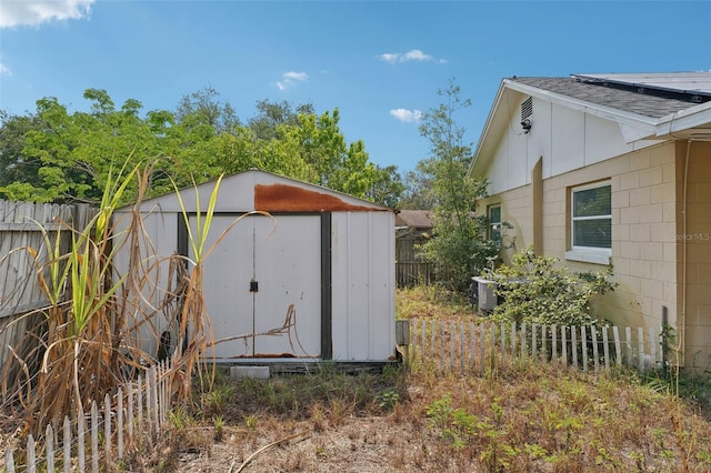 503 Holt Cir, Winter Haven, FL 33880 - view of shed featuring a fenced backyard and solar panels