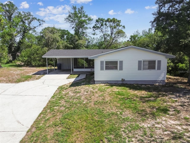 11409 Spring Hill Dr, Spring Hill, FL 34609 - single story home featuring a carport, concrete driveway, and a front yard