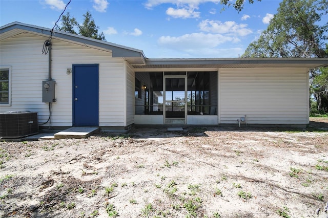 11409 Spring Hill Dr, Spring Hill, FL 34609 - back of house with central AC and a sunroom