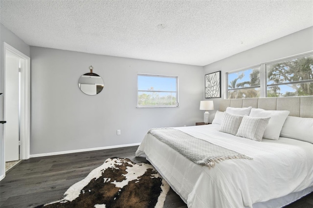 11409 Spring Hill Dr, Spring Hill, FL 34609 - bedroom featuring wood finished floors, a textured ceiling, and baseboards