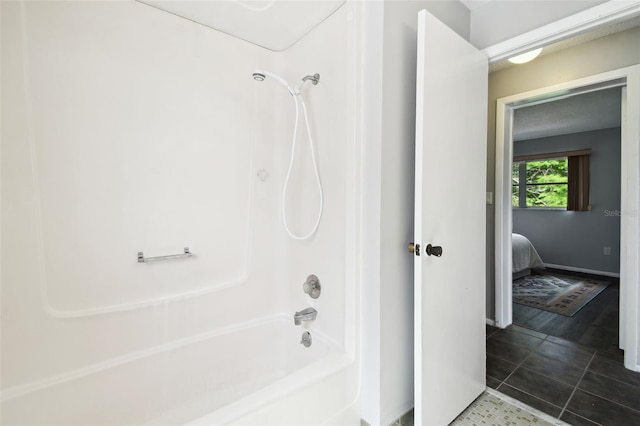 11409 Spring Hill Dr, Spring Hill, FL 34609 - ensuite bathroom with bathtub / shower combination, tile patterned flooring, and baseboards