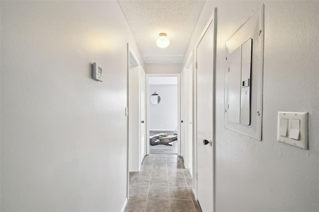 11409 Spring Hill Dr, Spring Hill, FL 34609 - hall with electric panel, a textured ceiling, tile patterned flooring, and baseboards