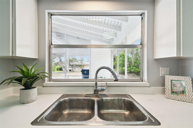 11409 Spring Hill Dr, Spring Hill, FL 34609 - kitchen view of a sink, light countertops, and white cabinetry
