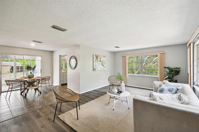 11409 Spring Hill Dr, Spring Hill, FL 34609 - living area featuring dark wood-type flooring, a textured ceiling, and baseboards