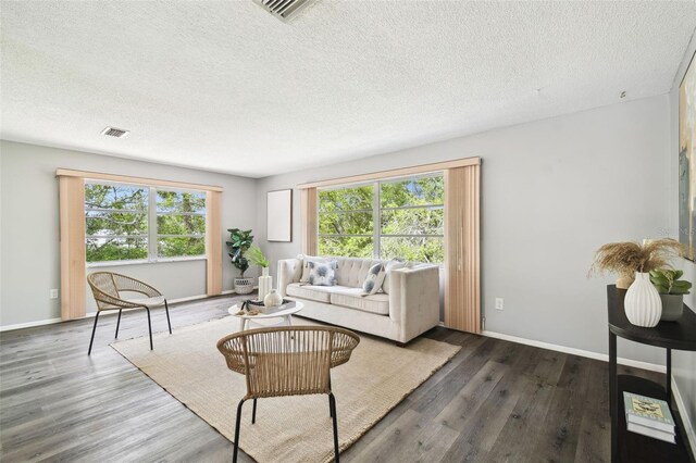 11409 Spring Hill Dr, Spring Hill, FL 34609 - living area featuring a textured ceiling, wood finished floors, and baseboards