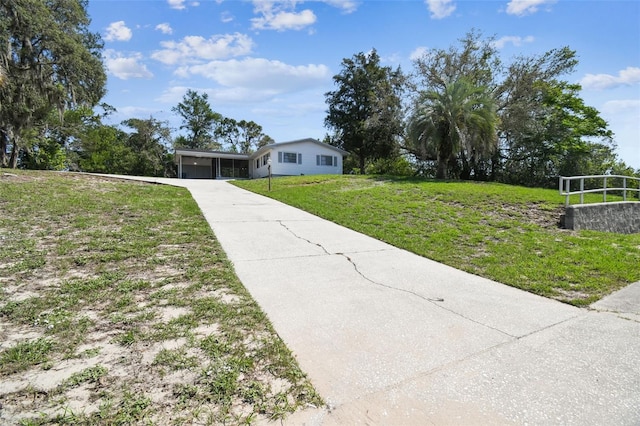 11409 Spring Hill Dr, Spring Hill, FL 34609 - view of front of house with driveway, a front lawn, and a garage